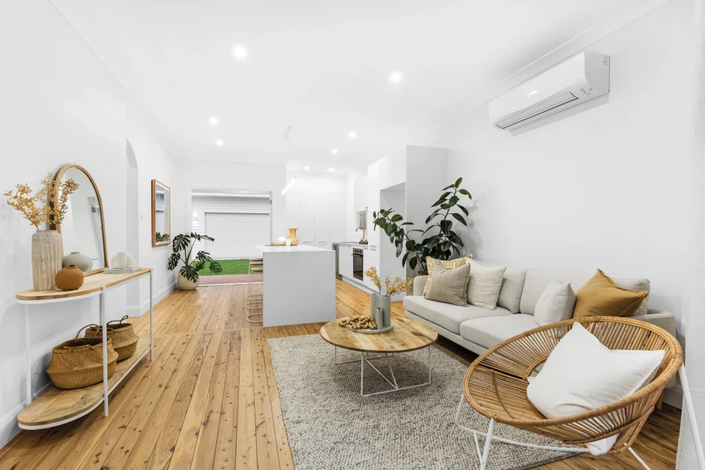 Open-concept kitchen and living area with large island bench in a Newcastle renovation project