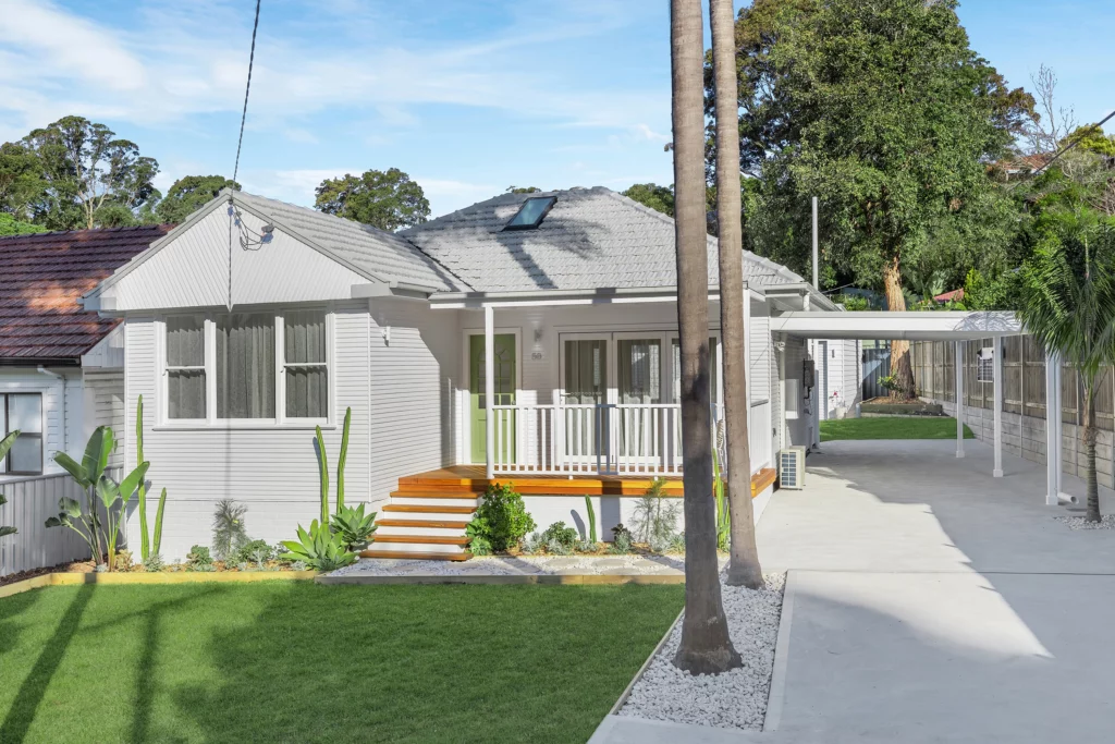 Refreshed home exterior with new cladding and updated roofing in Newcastle renovation