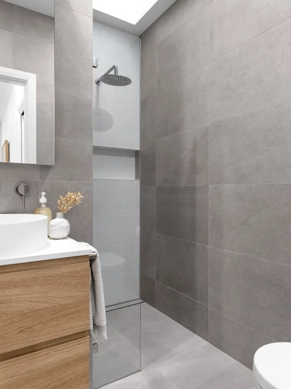 Luxury bathroom renovation featuring floor-to-ceiling tiles