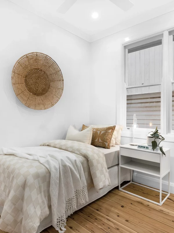 Modernised bedroom with timber floorboards, and soft neutral colours