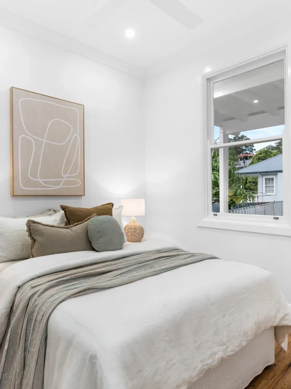 Chic bedroom design with timber floors and modern ceiling fan