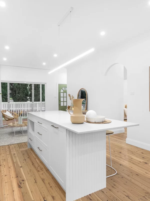 Modern kitchen renovation with white cabinetry and marble countertops in Newcastle home