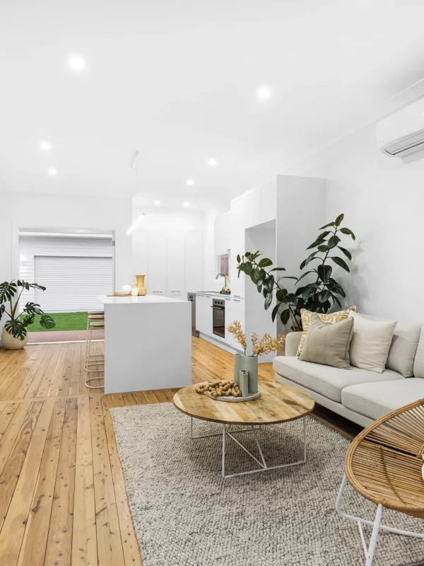 Open-concept kitchen and living area with large island bench in a Newcastle renovation project